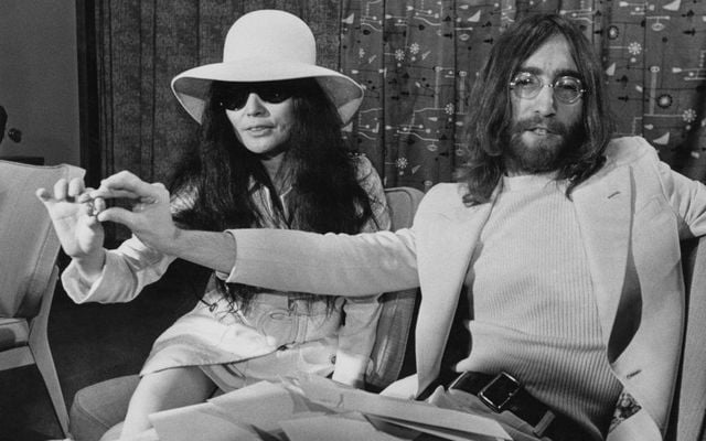 Singer and songwriter John Lennon (1940 - 1980) of English rock band the Beatles and his wife Yoko Ono holding acorns during a press conference at Heathrow Airport in London, 1st April 1969. 