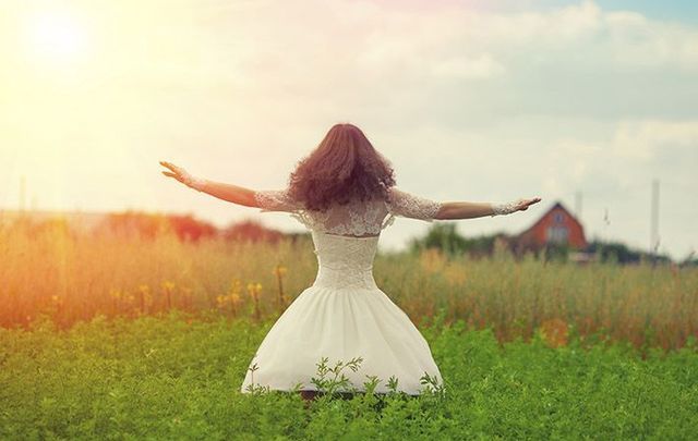 A woman with arms raised celebrating Lughnasa 2017/ 