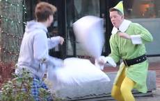 Boston firefighter dressed as "Buddy the Elf" challenges strangers to pillow fights