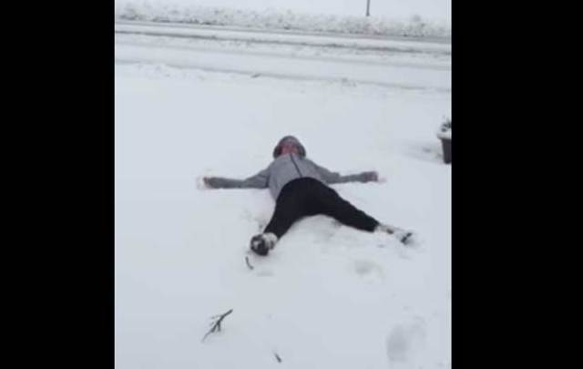 Irish woman attempts a snow angel.