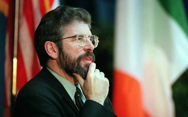 Sinn Fein President Gerry Adams flanked by the US and Irish flags in this photo dated March 12, 1998.