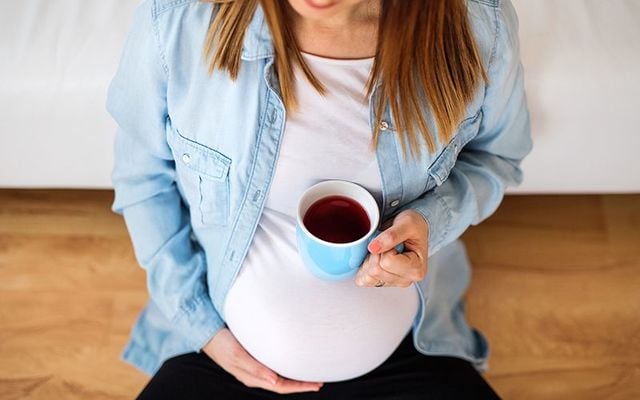 Pregnant woman drinking tea 