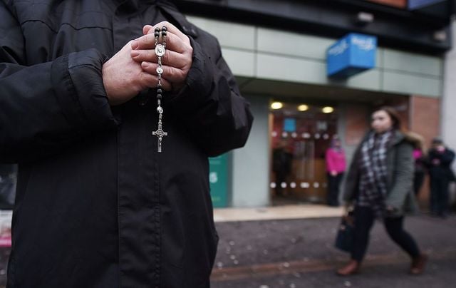 A pro-life activist prays with his rosary beads outside the Marie Stopes Clinic on January 12, 2016, in Belfast, Northern Ireland.