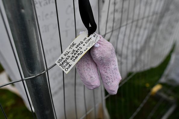 A vigil takes place at the site of the mass grave which contained the remains of 796 named babies from the Bon Secours Mother and Baby home on August 26, 2018, in Tuam, Ireland. 