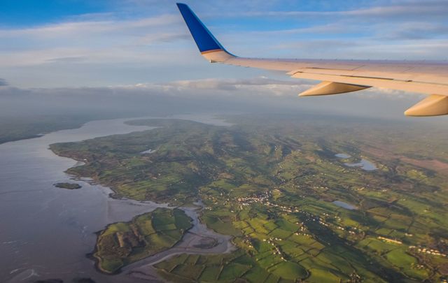 An airplane wing and a view from above of wild and impossibly green Ireland. 