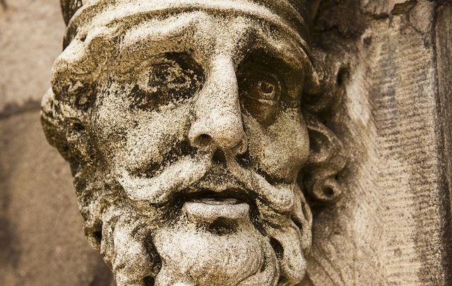 An old weathered statue of King Brian Boru of Ireland as seen on the outside of the Chapel Royal at the Dublin Castle.