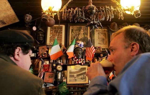 Patrons enjoy a beer in McSorley\'s Old Ale House in NYC