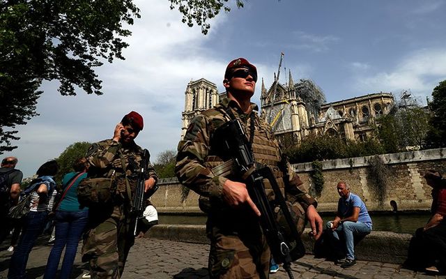Military patrol Notre Dame cathedral after the fire.