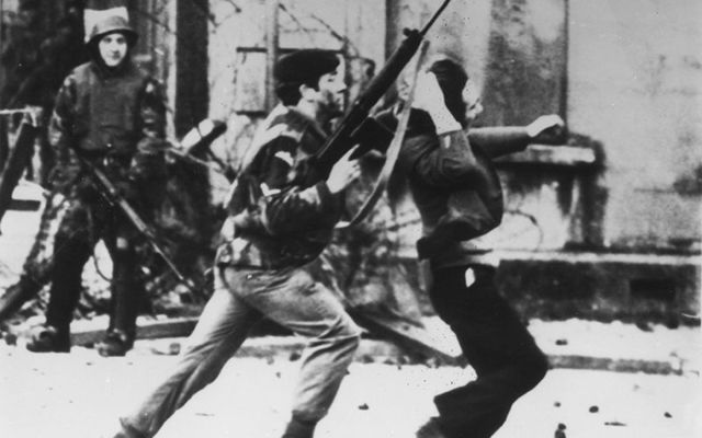 A British soldier and civil rights protester on Bloody Sunday.