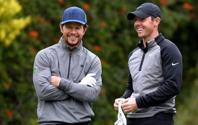 Actor Mark Wahlberg and Rory McIlroy of Northern Ireland laugh on the fourth tee during the Pro-Am at the Genesis Open on February 13, 2019, in Pacific Palisades, California.