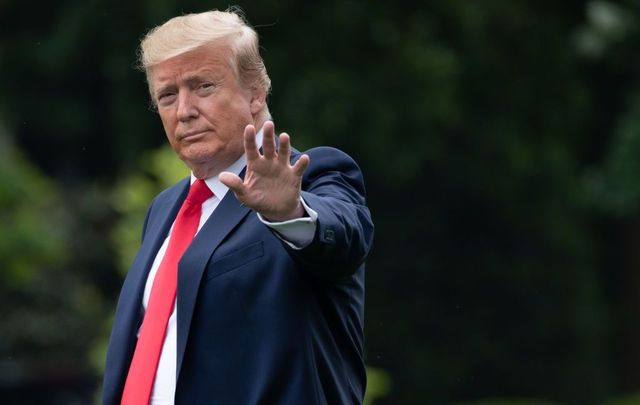 US President Donald Trump waves as he walks to Marine One while traveling to a \"Make America Great Again\" rally.