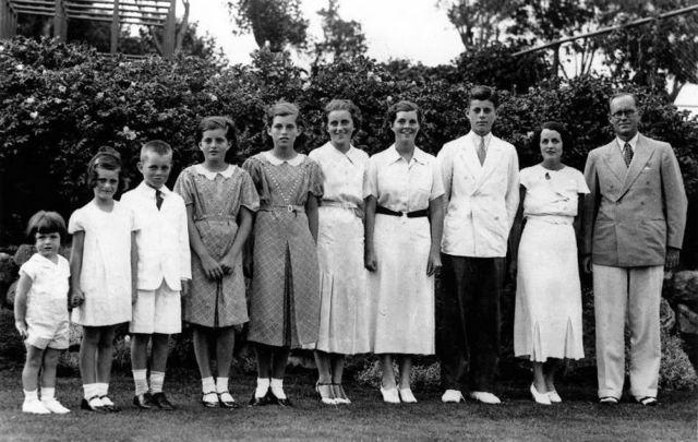 Joseph Patrick Kennedy, Sr and his wife Rose Kennedy (both far right) with eight of their nine children (L to R) Edward, Jeanne, Robert, Patricia, Eunice, Kathleen, Rosemary, and John in 1937.