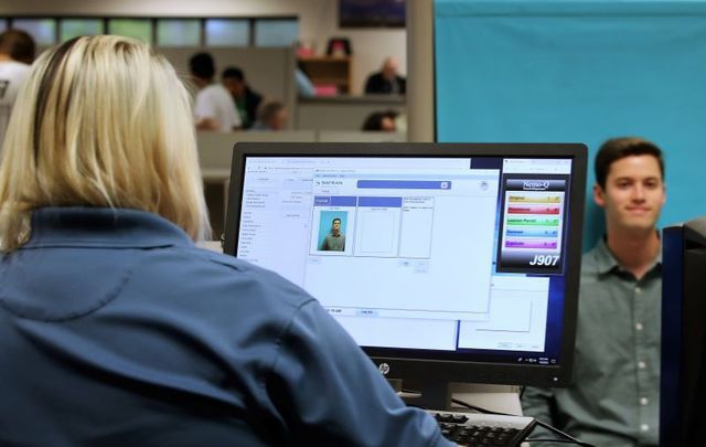 A man gets his picture taken at the DMV, whose databases ICE and FBI have been found to be mining.