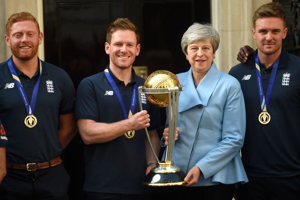 Jonny Bairstow, Eoin Morgan, and Theresa May pose with the Cricket World Cup at Downing Street on July 15, 2019, in London, England.