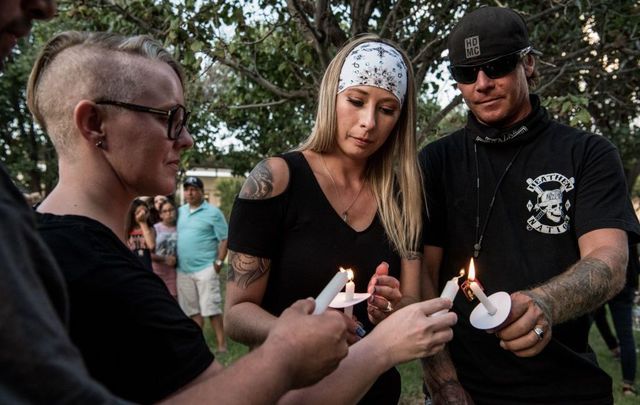People hold candles at the end of the prayer vigil at the University of Texas of the Permian Basin (UTPB) for the victims of a mass shooting, September 1, 2019, in Odessa, Texas.