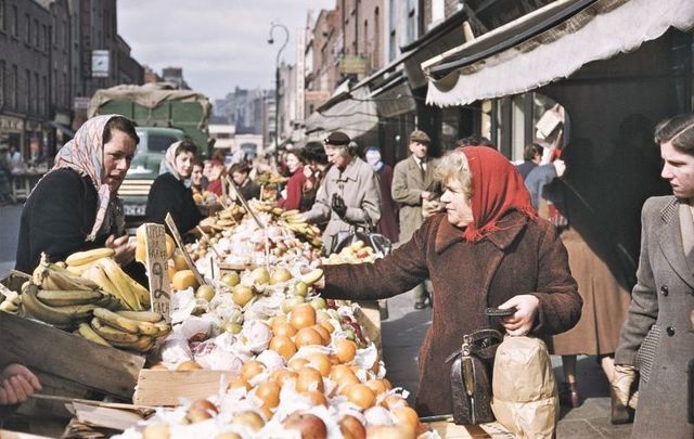 Shoppers at a fruit stall on a street in Dublin, Eire, June 1955. How history, oral tradition, and literature can remind us of Ireland\'s great tradition of food.