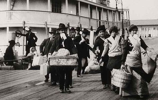 Emigrants landing at Ellis Island, New York: Emigrants have two homes, two places where they have to take us in – and hurray for that.