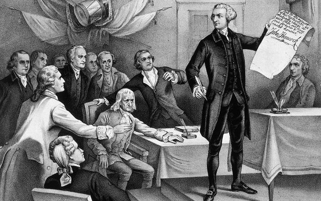 July 4, 1776: John Hancock (1737 - 1793), president of the Continental Congress, is the first to put his signature to the Declaration of Independence, watched by fellow patriots Robert Morris, Samuel Adams, Benjamin Rush, Richard Henry Lee, Charles Carroll, John Witherspoon, John Adams, and Edward Rutledge. Original Artwork: Printed by Currier & Ives.