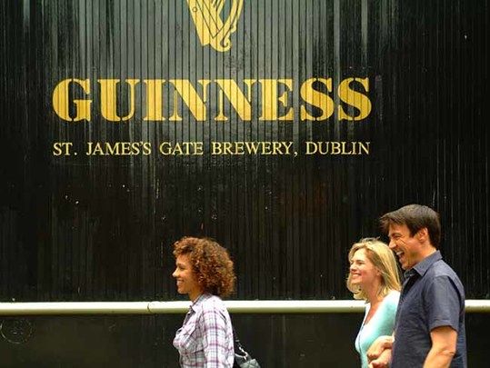 Tourists walking passed St. James\' Gate.