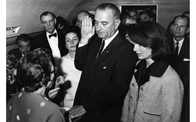 November 22, 1963: Lyndon B. Johnson takes the oath of office as President of the United States, after the assassination of President John F. Kennedy.