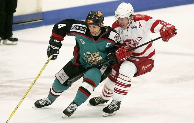  Shane Johnson of the Belfast Giants battles with Mark Gouett of the London Racers during the Elite League match between London Racers and Belfast Giants at the Lea Valley Ice Centre on December 3, 2004, in London.