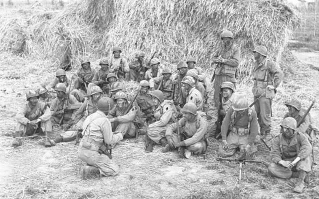 Forcemen of 5-2, First Special Service Force, preparing to go on an evening patrol in the Anzio beachhead, Operation Shingle, Italy, ca. 20-27 April 1944.