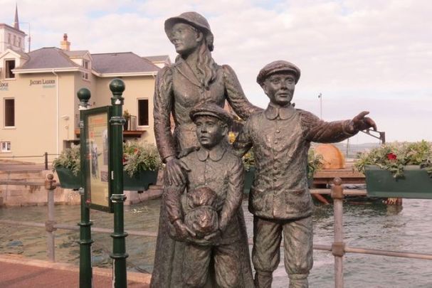 A statue dedicated to Annie Moore and her younger brothers in Cobh. 