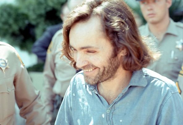 American criminal and cult leader Charles Manson (1934 - 2017) is escorted by Los Angeles County sheriffs to a police van to the Santa Monica Courthouse to appear in court for a hearing regarding the murder of music teacher Gary Hinman, Los Angeles, California, June 25, 1970.