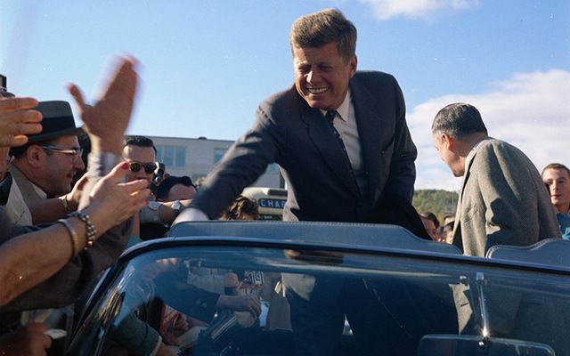 During a campaign trip, Senator John F. Kennedy greets a roadside crowd in Indiana.\n
