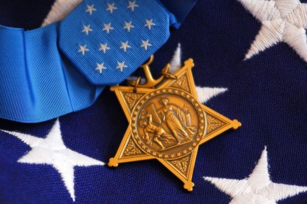 October 2, 2007: The Medal of Honor rests on a flag beside a SEAL trident during preparations for an award ceremony for Lt. Michael P. Murphy in Washington DC. Murphy was killed by enemy forces during a reconnaissance mission, Operation Red Wing, on June 28, 2005, while leading a four-man team tasked with finding a key Taliban leader in the mountainous terrain near Asadabad, Afghanistan.