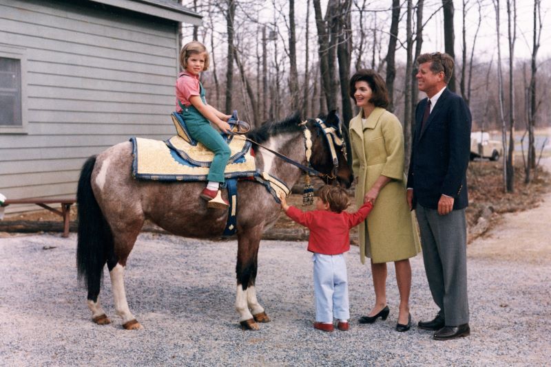 March 31, 1963: US President John F Kennedy with his wife, First Lady Jacqueline Bouvier Kennedy, as their daughter, Caroline, sits atop a pony and their son, John Jr. (Getty Images)