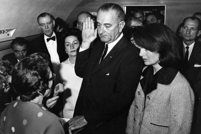 Lyndon B. Johnson being sworn in as president on Air Force One with Jackie Kennedy by his side (Getty Images)