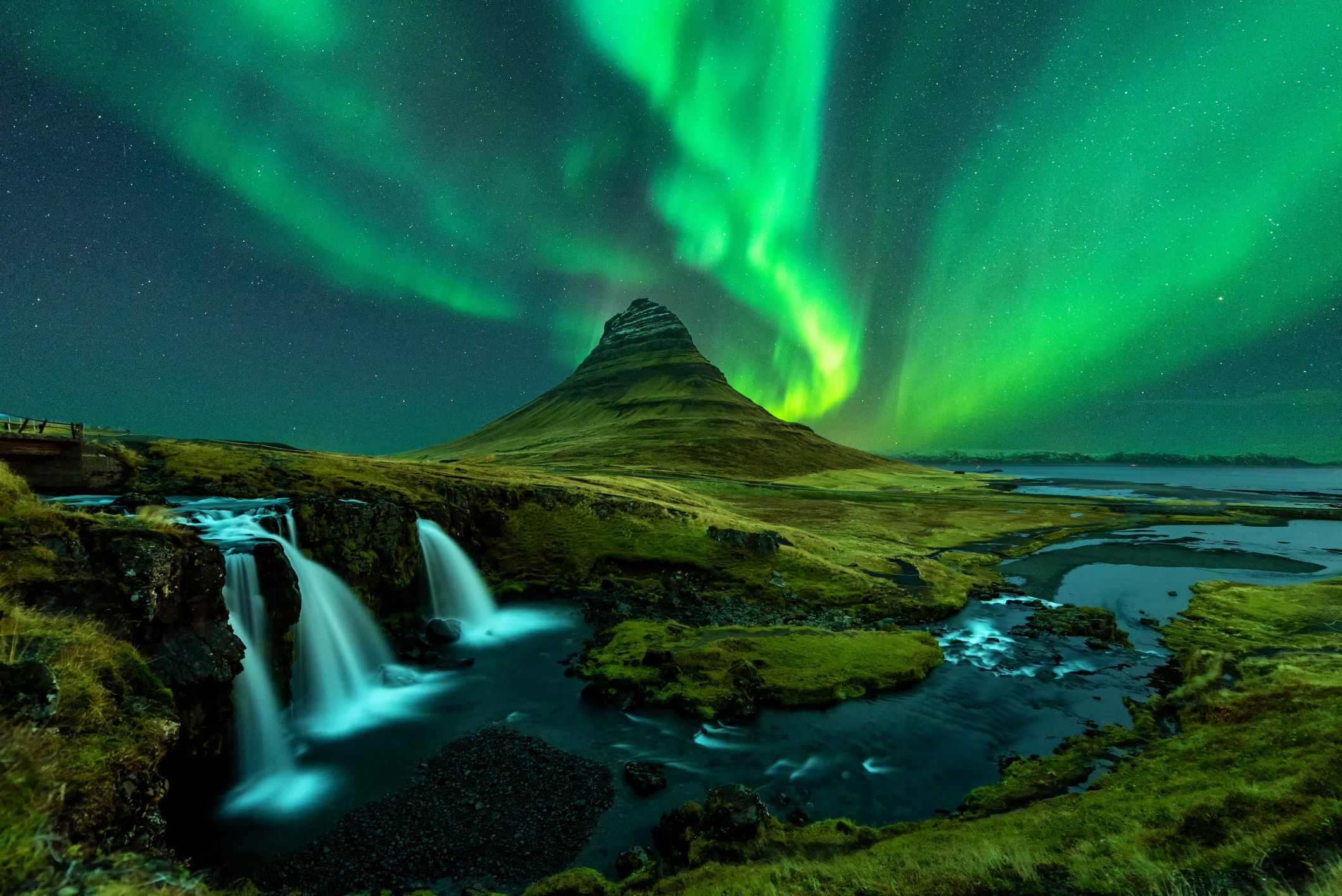 Northern Lights appear over Mount Kirkjufell with Kirkjufellfoss waterfall in Iceland. Image: Getty. 