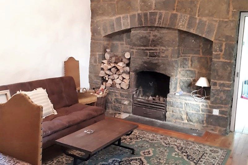 Moon Cottage's living room with feature fireplace (PremierePropertiesIreland.com)
