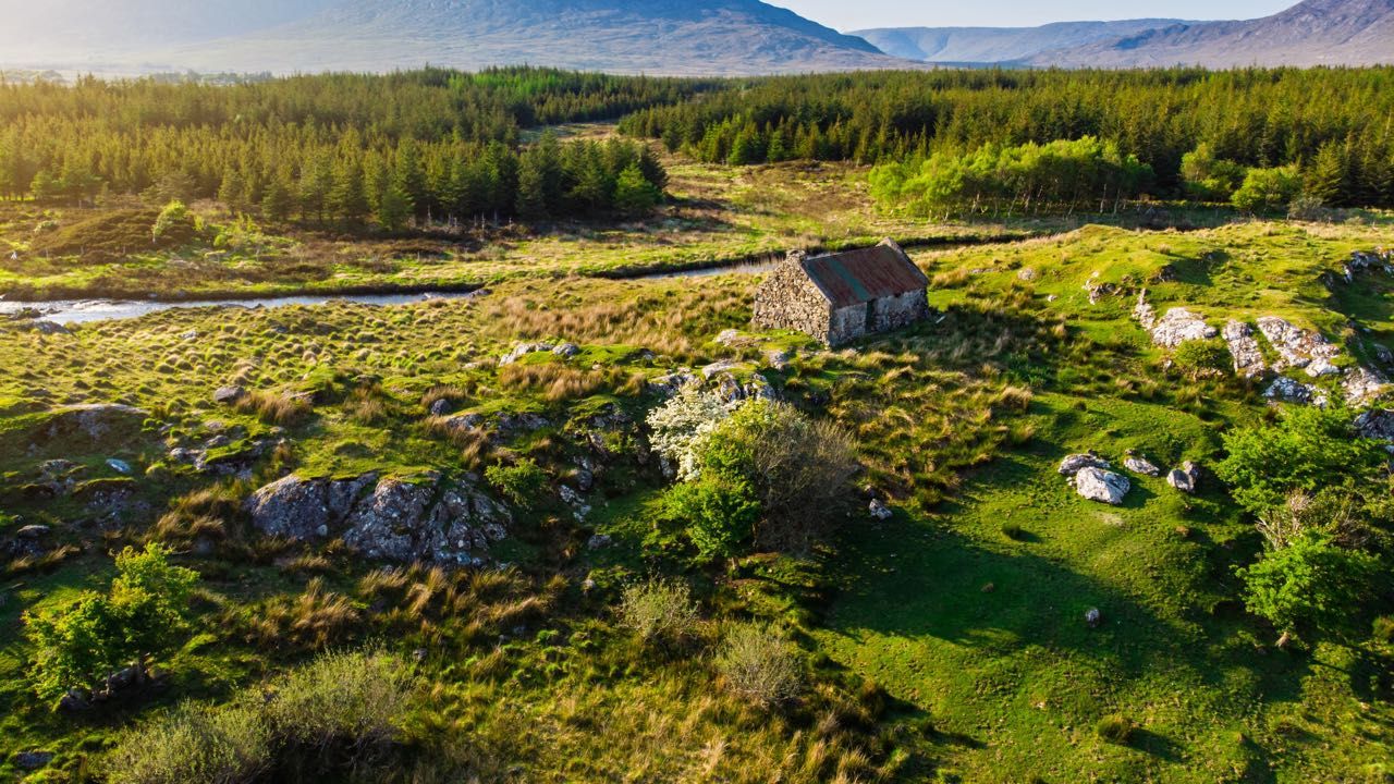 An old cottage along a river in Connacht