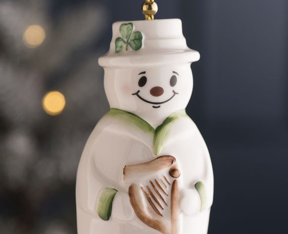 A Belleek Pottery Christmas decoration, a snowman bell. A Belleek Pottery Christmas decoration, a snowman bell.