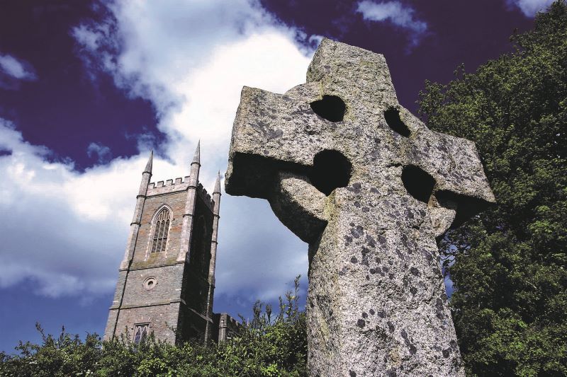 Down Cathedral with a Celtic Cross in the foreground. (Ireland's Content Pool)