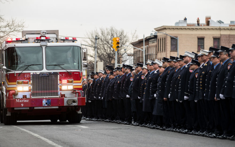 FDNY officers pay respects to fallen heroes.