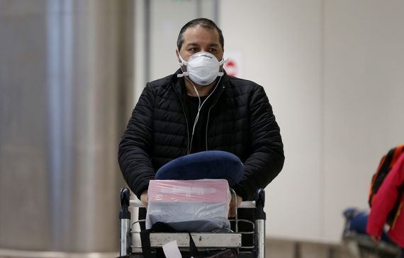 A man wearing a medical mask at Dublin airport. A man wearing a medical mask at Dublin airport.
