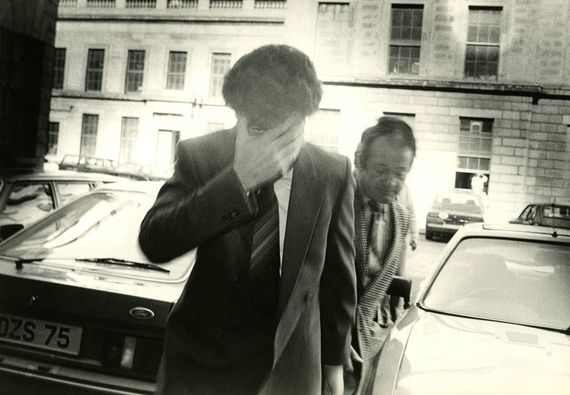 Larry Dunne covering his face, exiting court. Larry Dunne covering his face, exiting court.