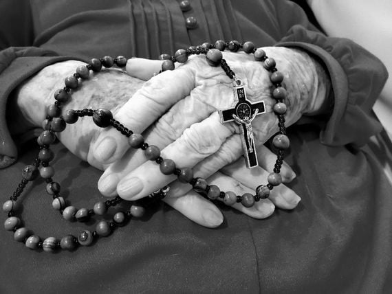 Saying the rosary over my mother's dead body. Saying the rosary over my mother's dead body.