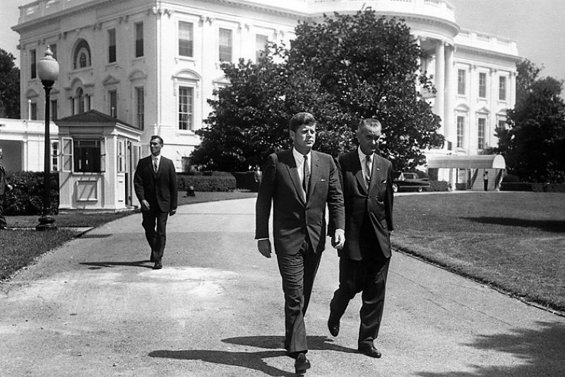 President Kennedy and Vice President Johnson prior to ceremony for the Workmens' Compensation Commemorative Stamp, Washington, D. C., White House, South Lawn, August 31, 1961. (US National Park Service / Public Domain) President Kennedy and Vice President Johnson prior to ceremony for the Workmens' Compensation Commemorative Stamp, Washington, D. C., White House, South Lawn, August 31, 1961. (US National Park Service / Public Domain)