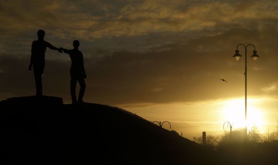 Hands reach across the divide in Derry (Getty Images) Hands reach across the divide in Derry (Getty Images)