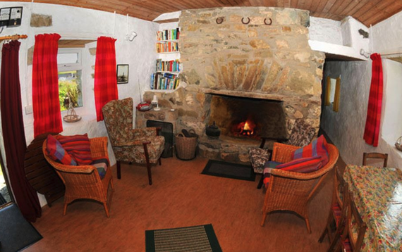 The living room, including open fire, at Carries Cottage, in Dunloughan, Ballyconneely. The living room, including open fire, at Carries Cottage, in Dunloughan, Ballyconneely.