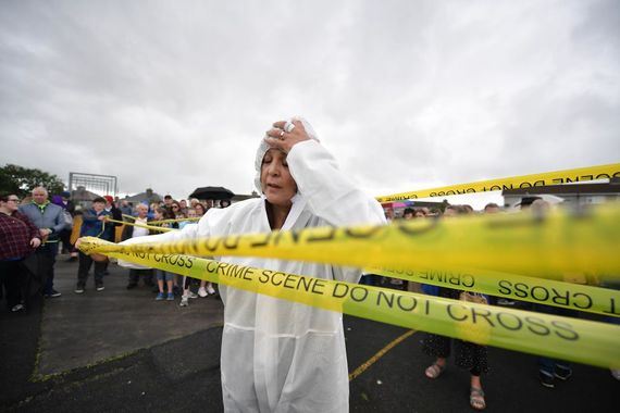 August 26, 2018: A woman dressed as a crime scene officer holds a protest as a vigil takes place at the site of the mass grave which contained the remains of 796 named babies from the Bon Secours Mother and Baby home in Tuam, Ireland. (Getty Images) August 26, 2018: A woman dressed as a crime scene officer holds a protest as a vigil takes place at the site of the mass grave which contained the remains of 796 named babies from the Bon Secours Mother and Baby home in Tuam, Ireland. (Getty Images)