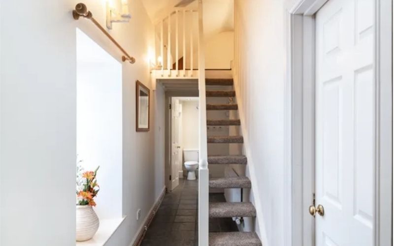 A cute narrow staircase leads to a beautiful timber-floored loft room A cute narrow staircase leads to a beautiful timber-floored loft room