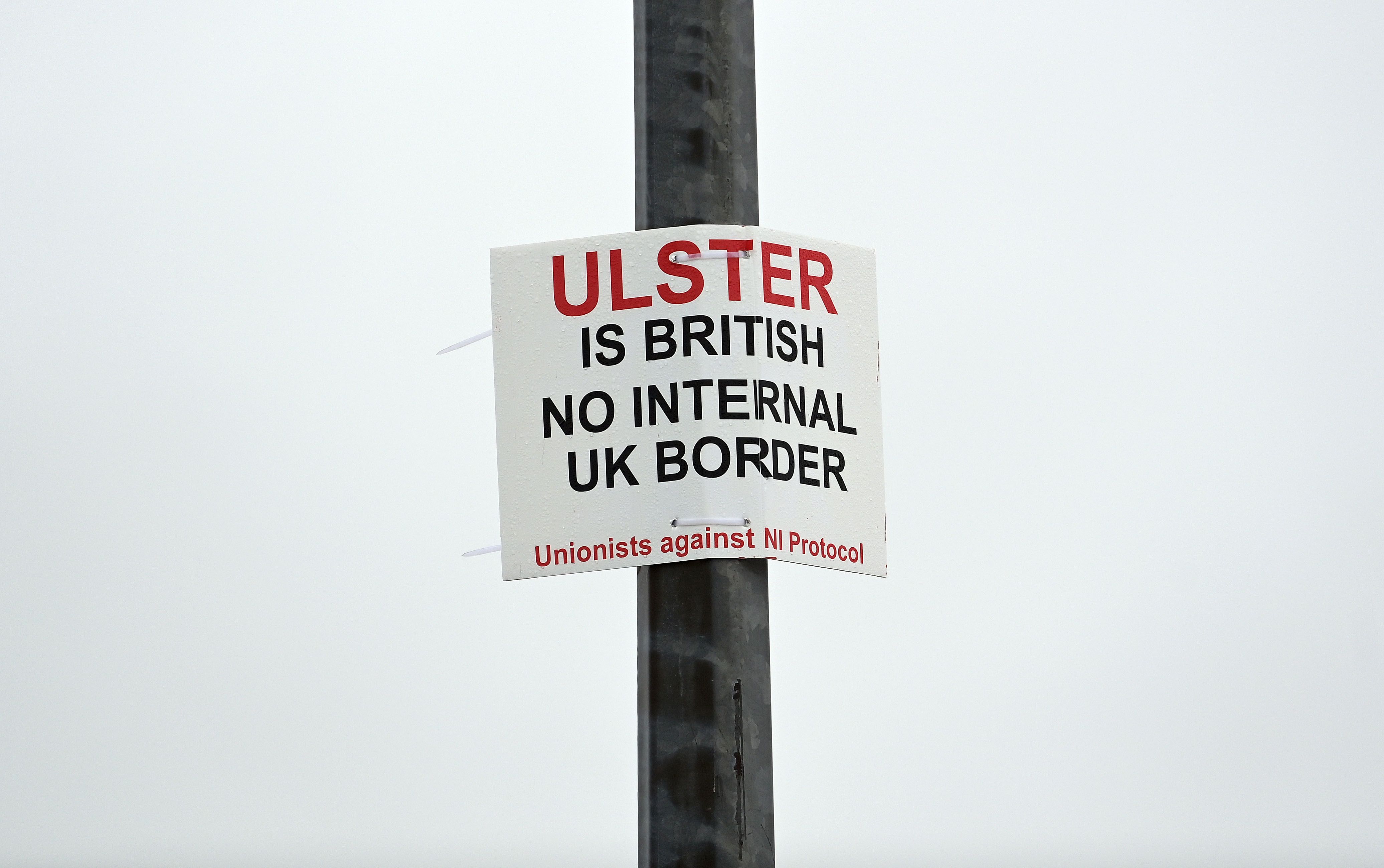 A signpost threatening workers at Larne. Getty