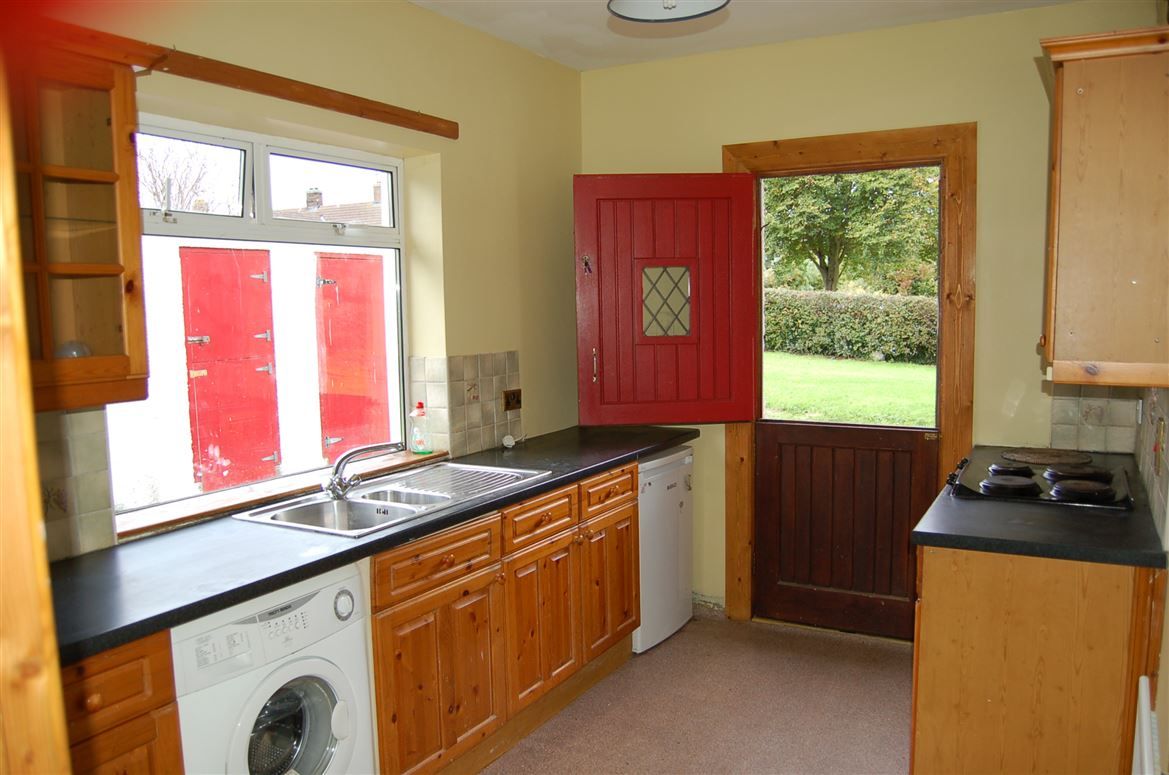 The kitchen area with a charming half-door painted red The kitchen area with a charming half-door painted red
