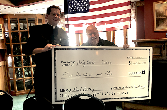 Father Chris Heanue from Holy Child Jesus in Richmond Hill receives a donation from Francis McLoughlin. Father Chris Heanue from Holy Child Jesus in Richmond Hill receives a donation from Francis McLoughlin.