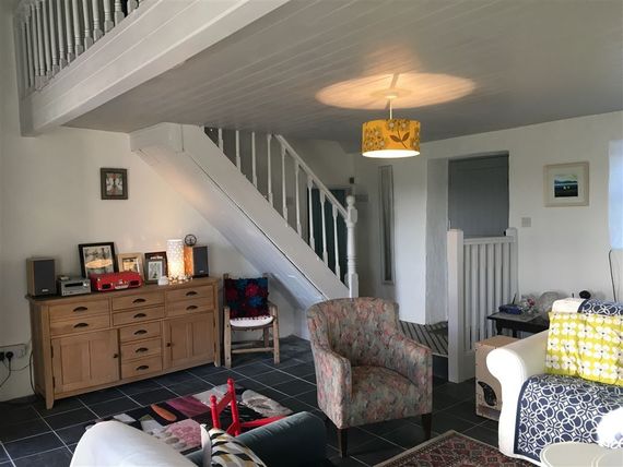 The spacious living room inside the thatched cottage The spacious living room inside the thatched cottage